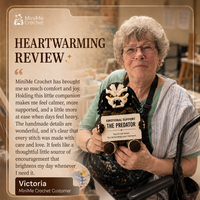 A woman with short curly gray hair and glasses holds a handmade black crochet creature doll with a white embroidered face and a sign reading 'EMOTIONAL SUPPORT THE PREDATOR.' The image includes a branded review panel with the MiniMe Crochet logo and customer text on a warm beige background.